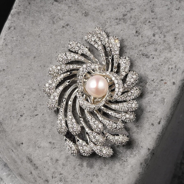 Silver diamante swirl with faux pearl brooch